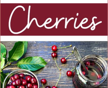 cherries on a dark tables and in a jar with leaves