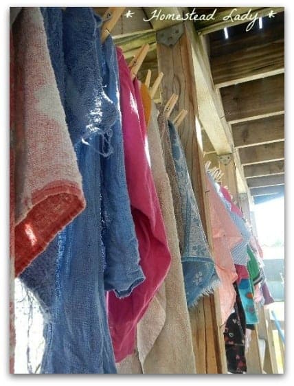 wet towels hanging from laundry line under a deck