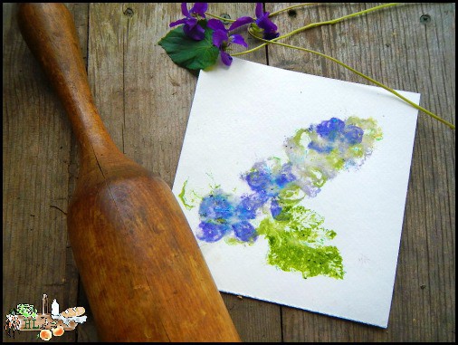 violets and violet print paper with wooden pounder