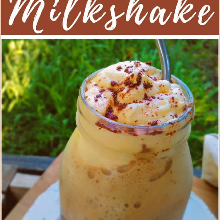 dandelion chocolate milkshake in a jar with a metal straw on a table