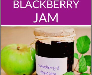 jar of blackberry apple jam with apples and blackberries on a table