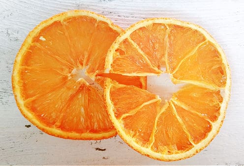 A close up of a slice of orange cut in half