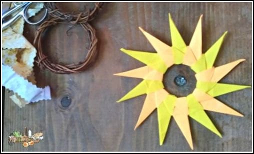 origami sun or star on wooden background