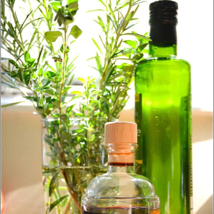 herbs and vinegar on a table